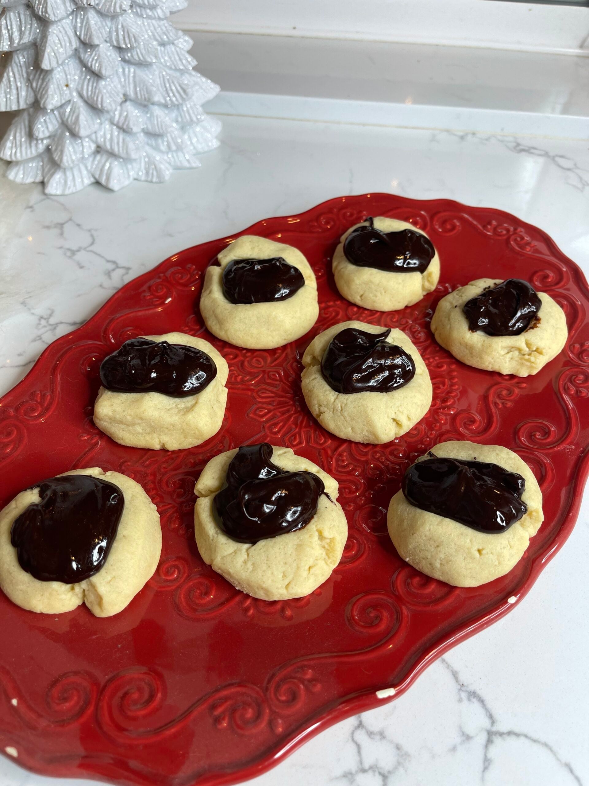 Learn how to make soft, buttery chocolate thumbprint cookies filled with silky homemade ganache. This easy thumbprint cookie recipe is perfect for holiday baking, gifting, and cookie swaps.